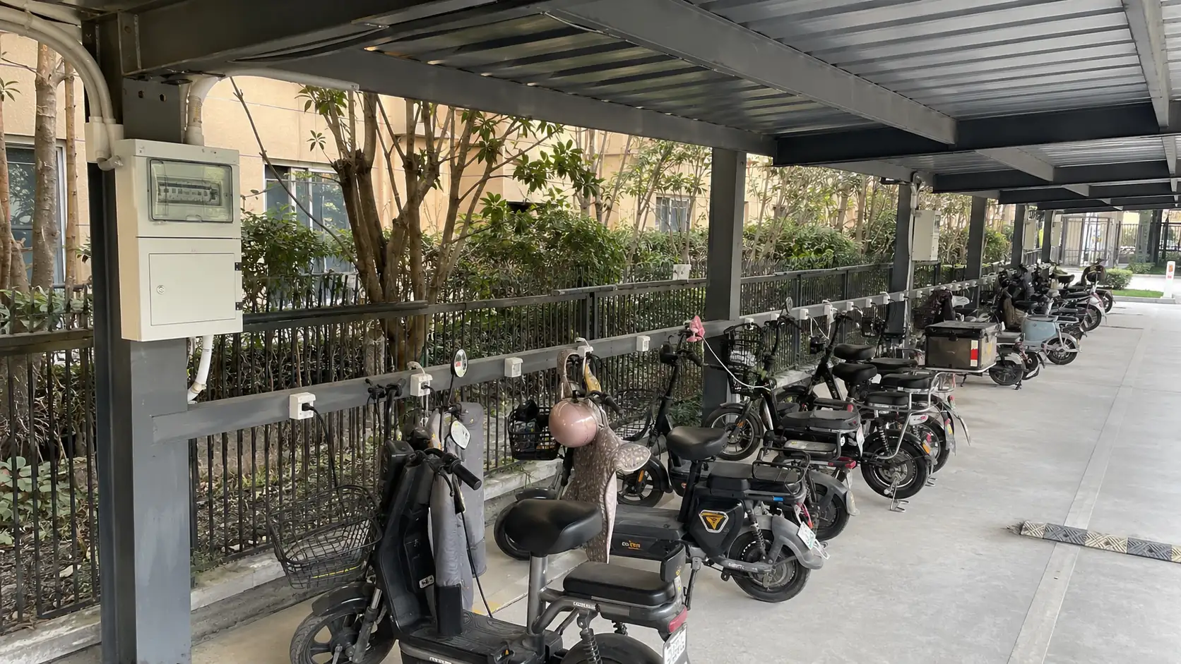 Residential e-bike charging area under a steel canopy